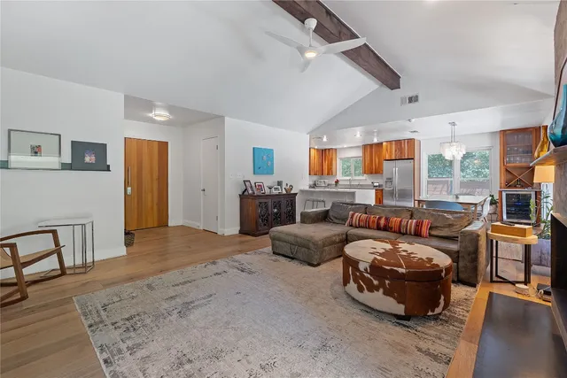 a bedroom with furniture a large window and a chandelier