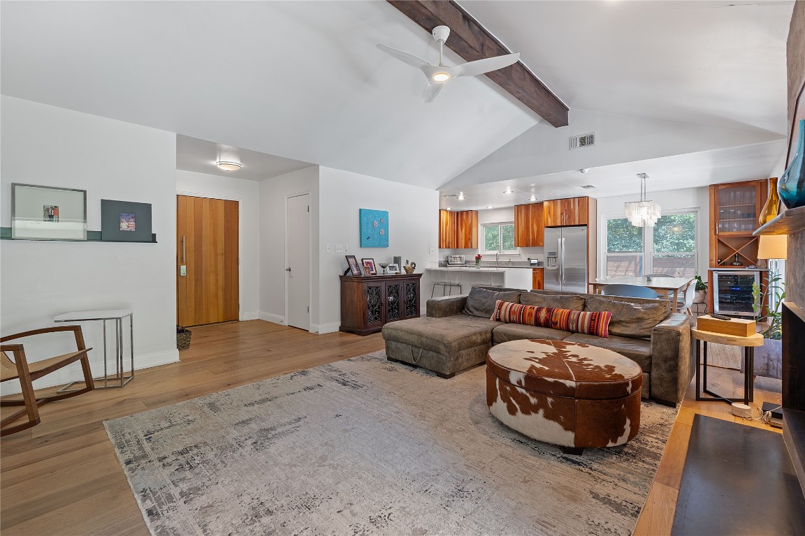 1407 Spring Garden Road Austin, TX 78746 - Photo 2 of 28 a bedroom with furniture a large window and a chandelier