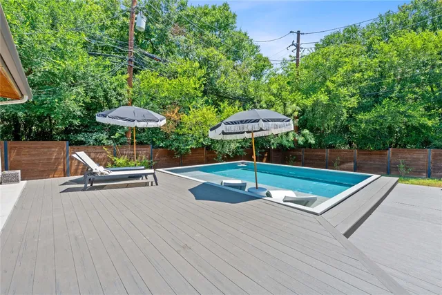 an outdoor space with pool and furniture