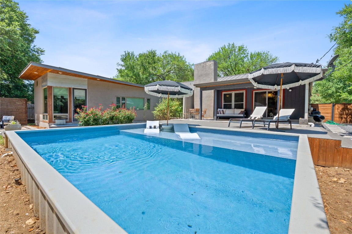1407 Spring Garden Road Austin, TX 78746 - Photo 22 of 28 a view of a house with pool and chairs