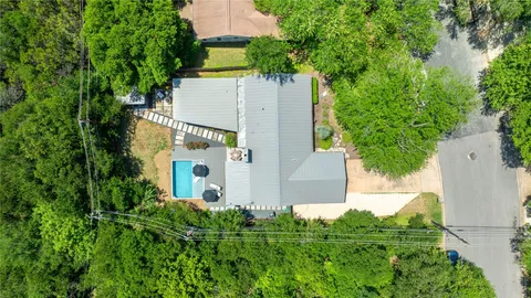 an aerial view of a house with a yard