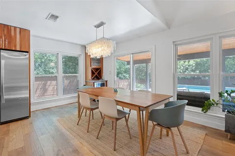 a view of a dining room with furniture wooden floor and chandelier