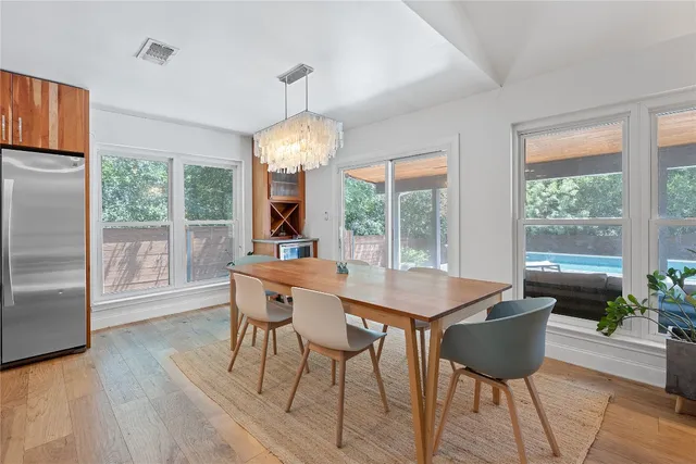 a view of a dining room with furniture wooden floor and chandelier