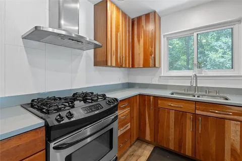 a kitchen with wooden cabinets and a stove top oven