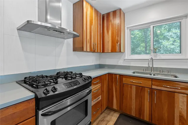a kitchen with wooden cabinets and a stove top oven