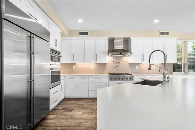 a kitchen with a sink stove and cabinets