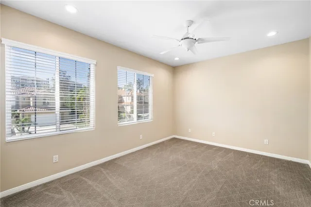 a spacious bathroom with a granite countertop sink a mirror and a shower