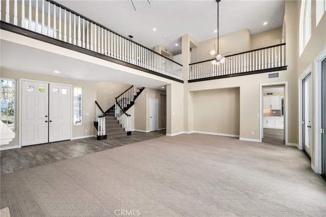 a view of an empty room with a fireplace and a window
