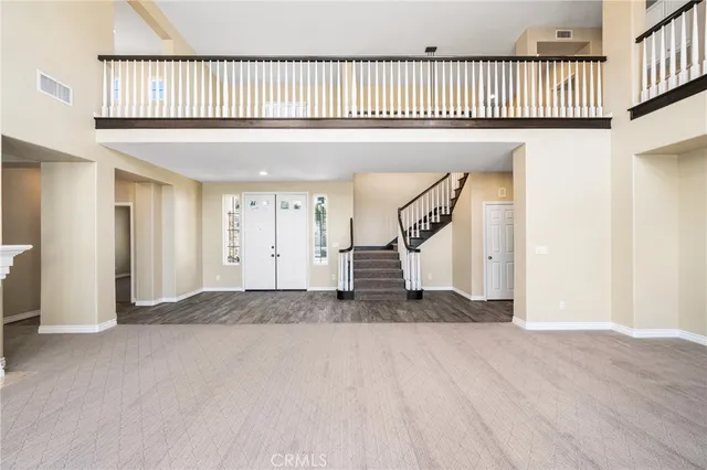 a view of an empty room with a fireplace and a window