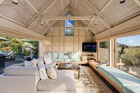 a bedroom with a bed and a large mirror