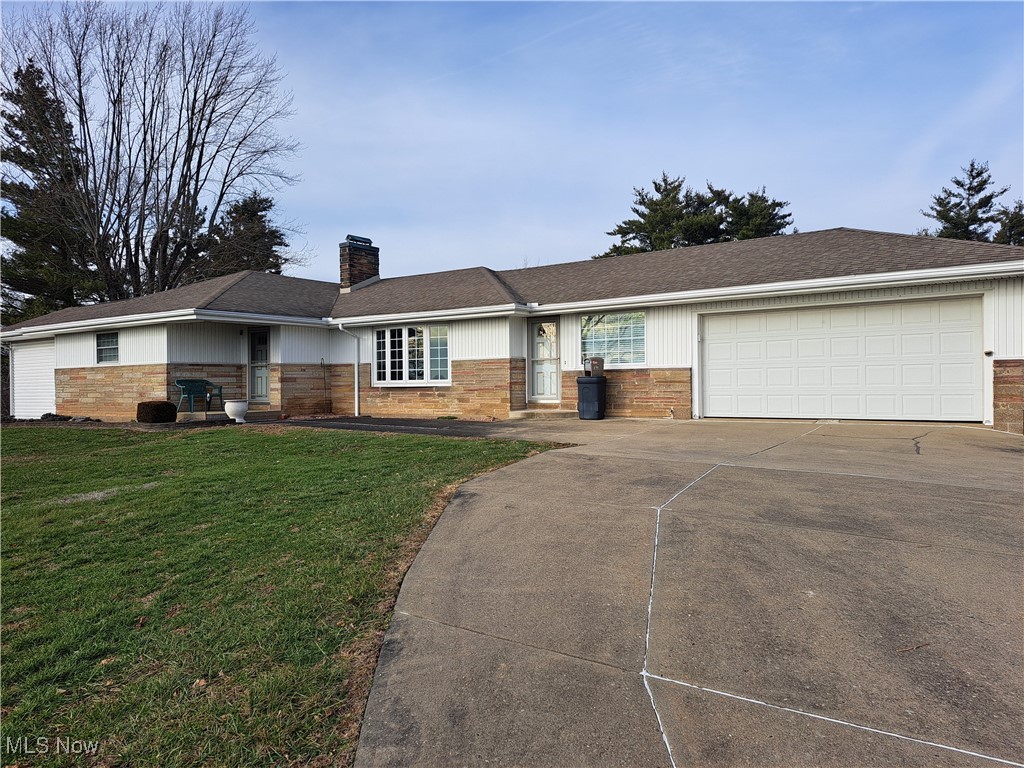 2781 Bloomfield Road Cambridge, OH 43725 - Photo 1 of 50 Ranch-style house featuring an attached garage, a chimney, concrete driveway, brick siding, and a front lawn