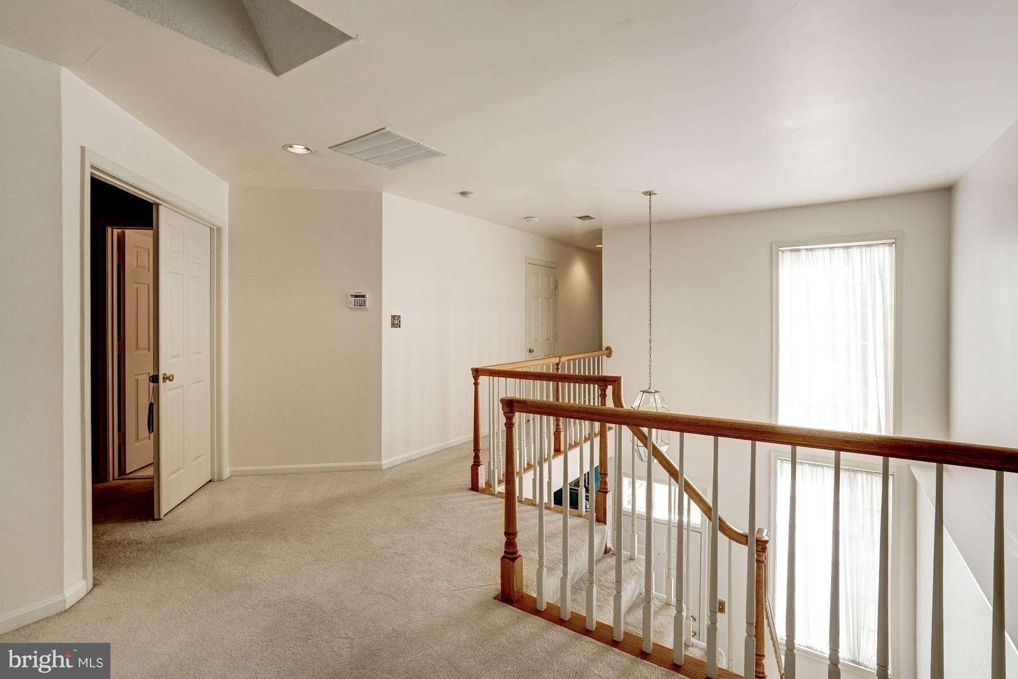11406 Hollow Timber Way Reston, VA 20194 - Photo 12 of 30 a view of a hallway with wooden floor and staircase