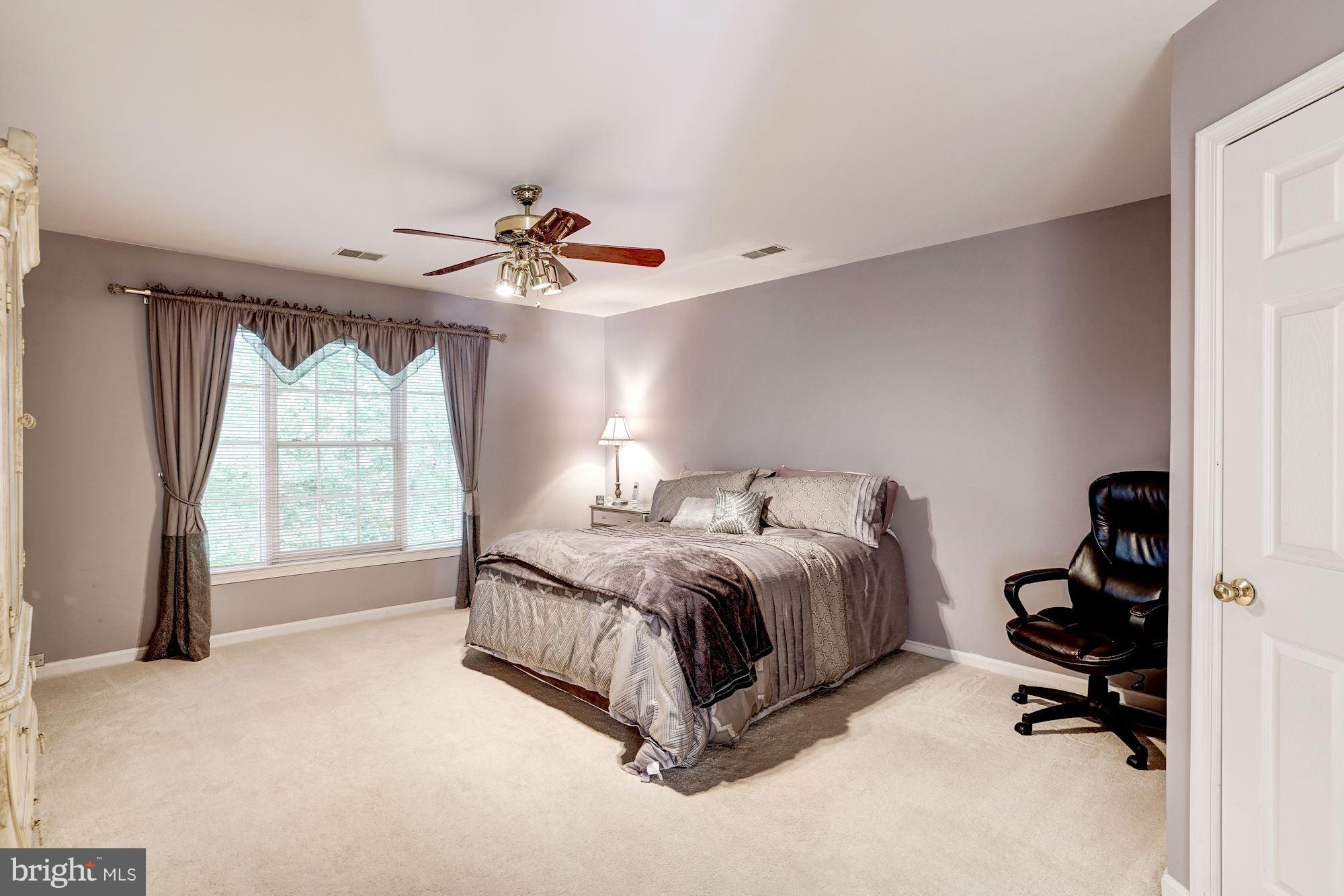 11406 Hollow Timber Way Reston, VA 20194 - Photo 15 of 30 a spacious bedroom with a bed and a large window