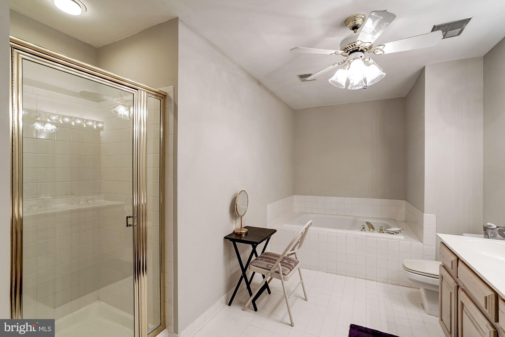 11406 Hollow Timber Way Reston, VA 20194 - Photo 17 of 30 a bathroom with a bathtub and a shower