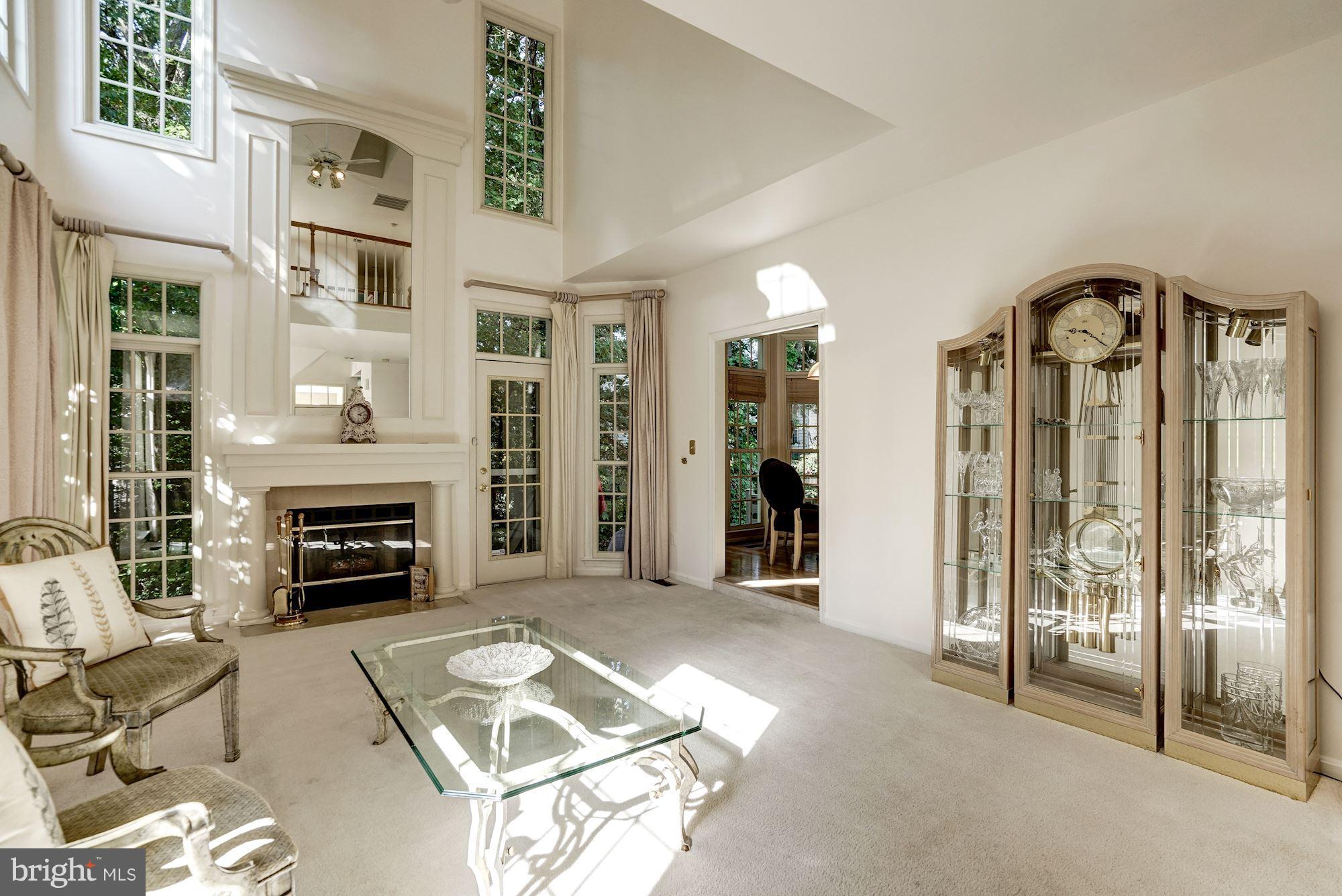 11406 Hollow Timber Way Reston, VA 20194 - Photo 4 of 30 a living room with furniture a fireplace and a flat screen tv