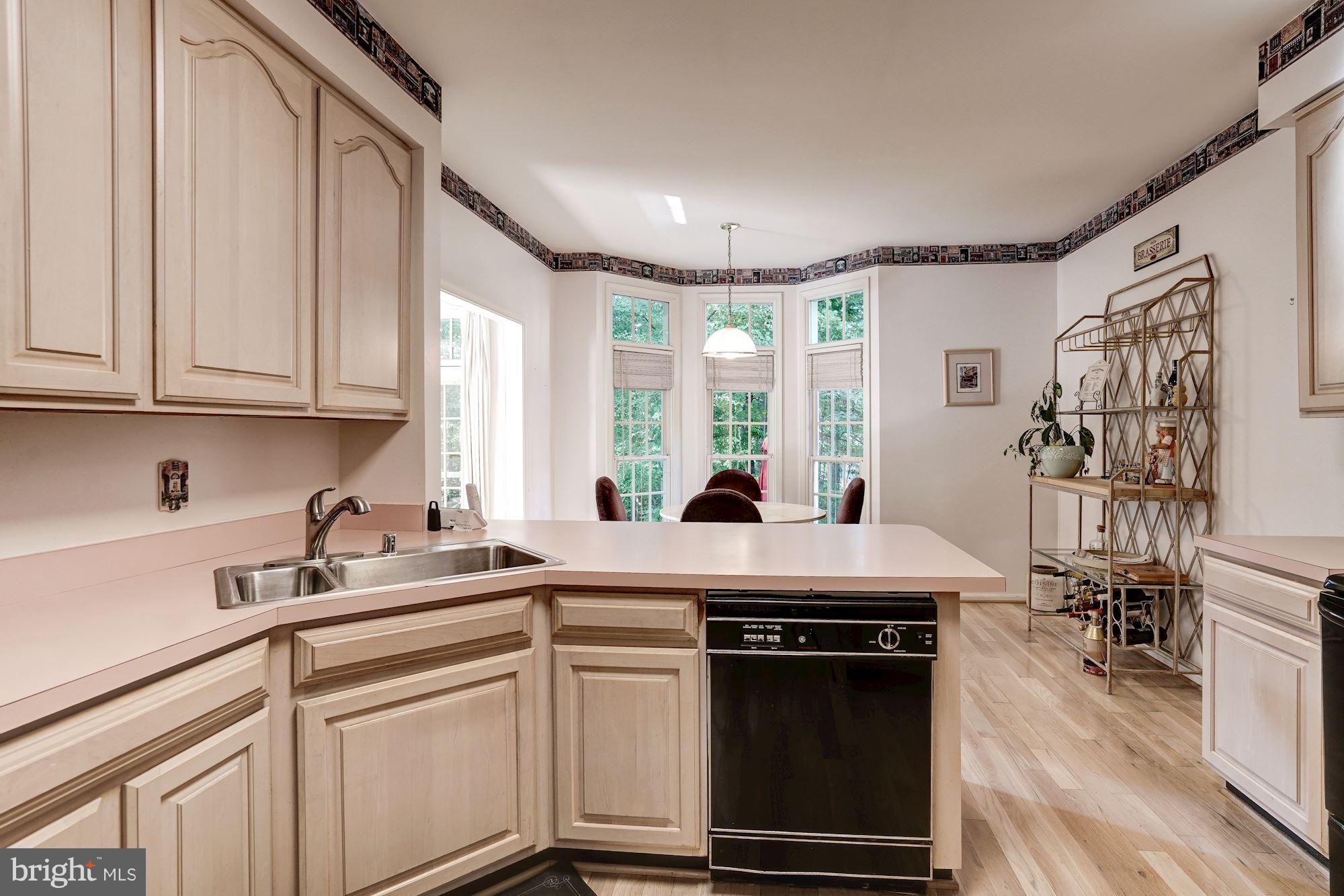 11406 Hollow Timber Way Reston, VA 20194 - Photo 8 of 30 a kitchen with stainless steel appliances granite countertop a sink stove and cabinets