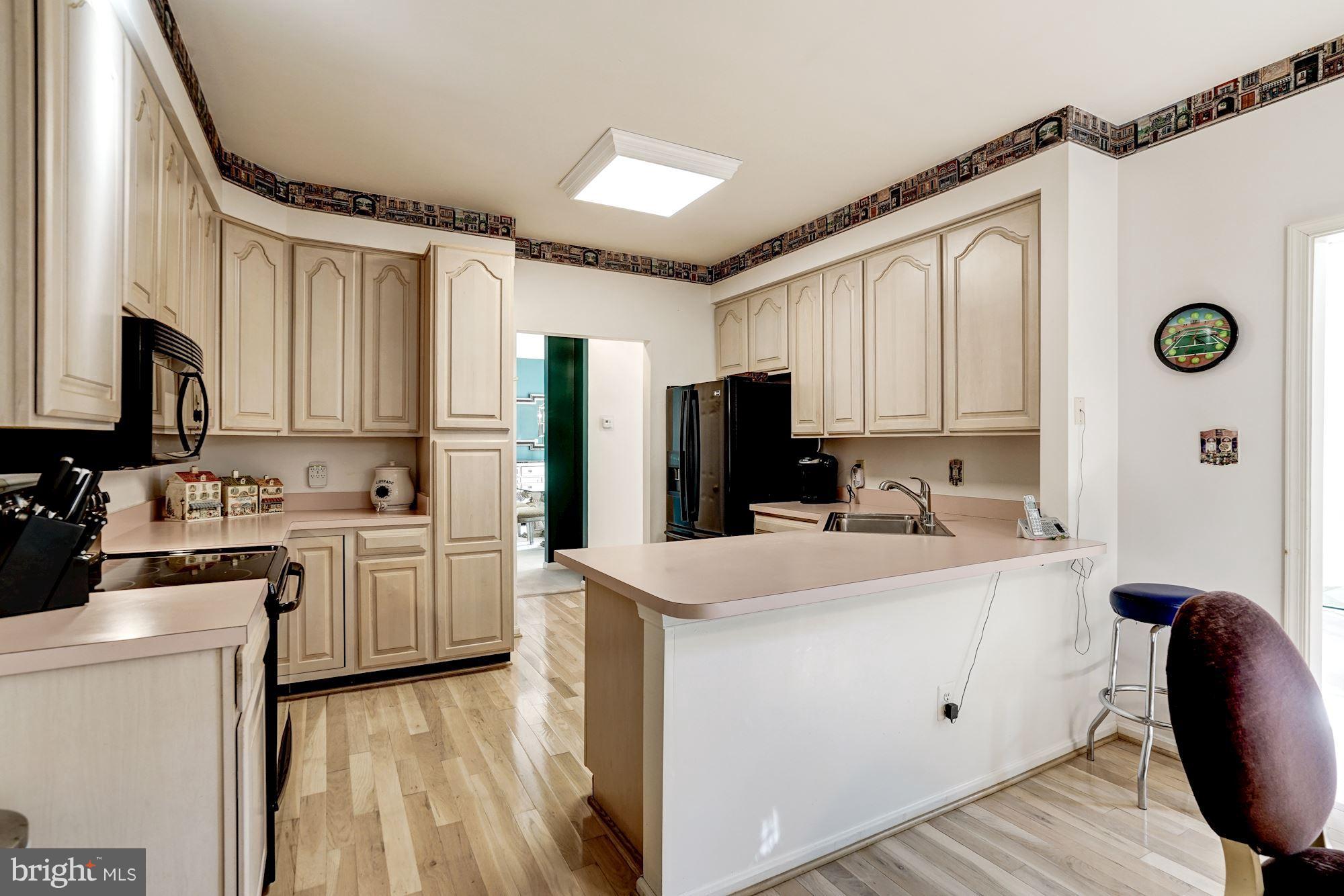 11406 Hollow Timber Way Reston, VA 20194 - Photo 9 of 30 a kitchen with cabinets and stainless steel appliances