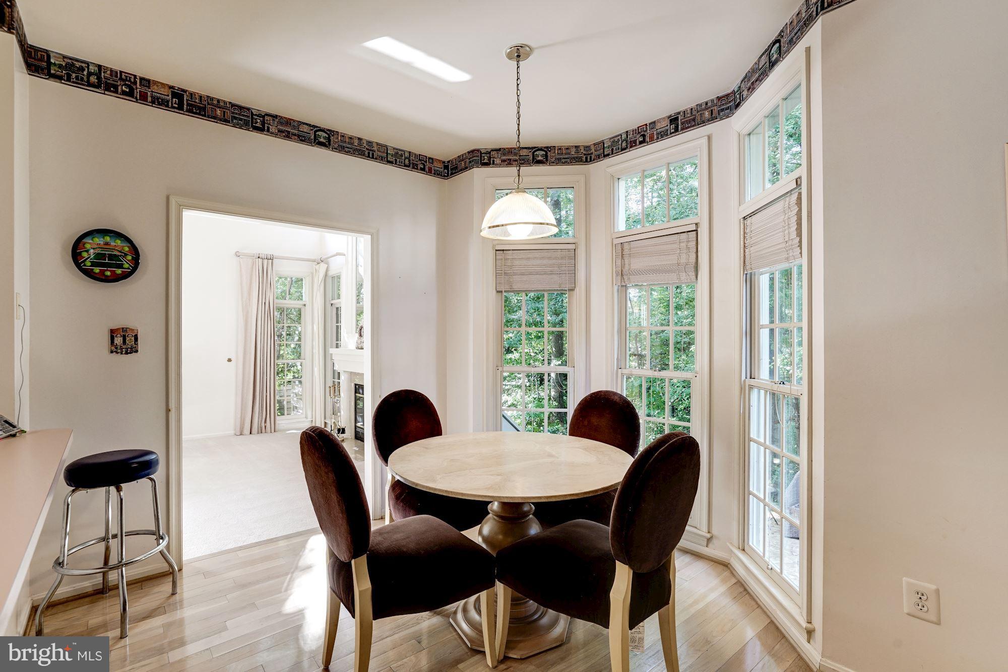 11406 Hollow Timber Way Reston, VA 20194 - Photo 10 of 30 a view of a dining room with furniture window and wooden floor