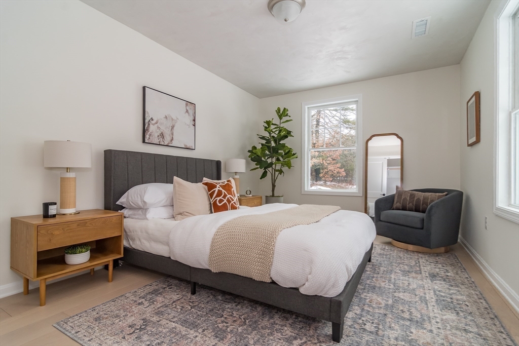 100 Oxbow Road Wayland, MA 01778 - Photo 13 of 17 a bedroom with a bed wooden floor and window
