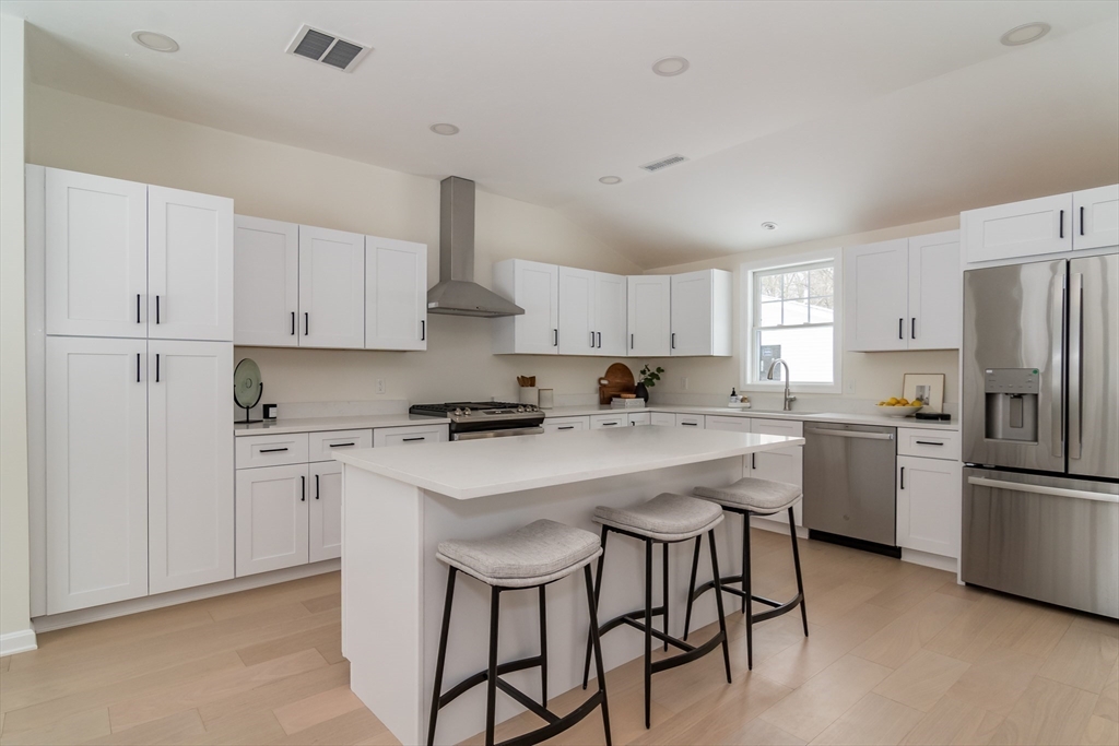 100 Oxbow Road Wayland, MA 01778 - Photo 6 of 17 a kitchen with white cabinets and white stainless steel appliances