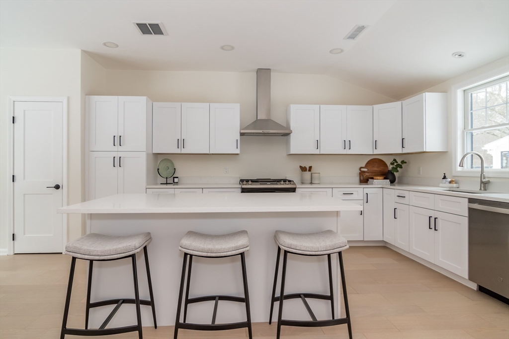 100 Oxbow Road Wayland, MA 01778 - Photo 7 of 17 a kitchen with stainless steel appliances a white table and chairs in it