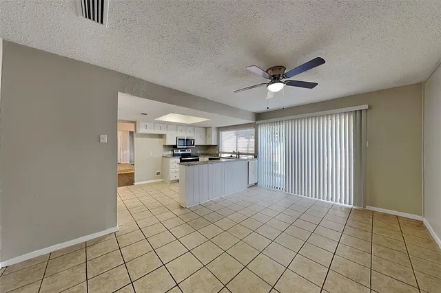 a view of kitchen with microwave and cabinets