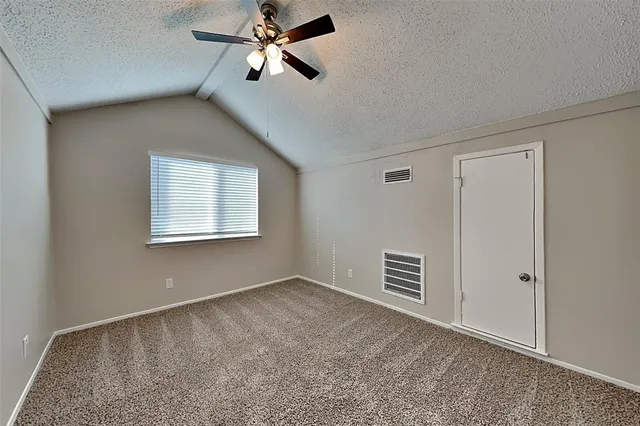 a view of a livingroom with a ceiling fan and window