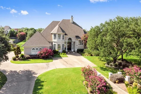 a front view of a house with a garden and yard