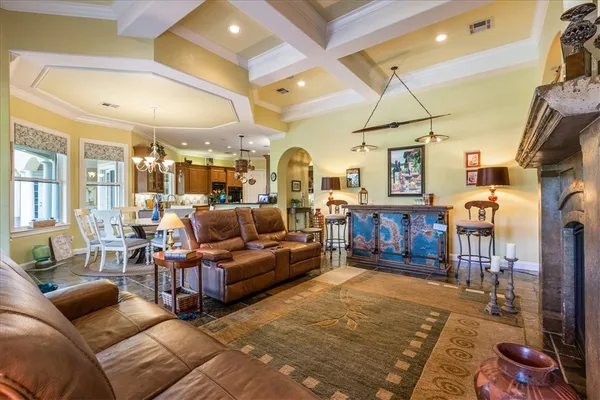 a kitchen with granite countertop a sink stainless steel appliances white cabinets and a window
