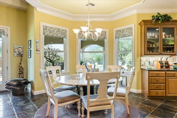 a living room filled with lots of furniture and a potted plant