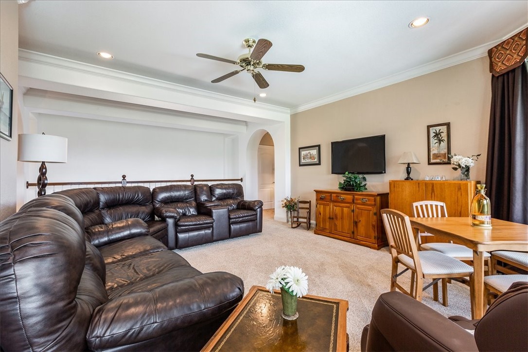 1021 Park Ridge Circle McGregor, TX 76657 - Photo 31 of 48 a living room with furniture a ceiling fan and a flat screen tv