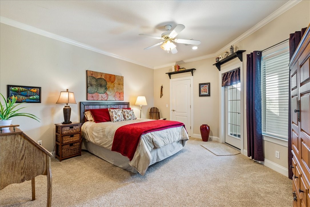 1021 Park Ridge Circle McGregor, TX 76657 - Photo 37 of 48 a spacious bedroom with a bed couch and a chandelier
