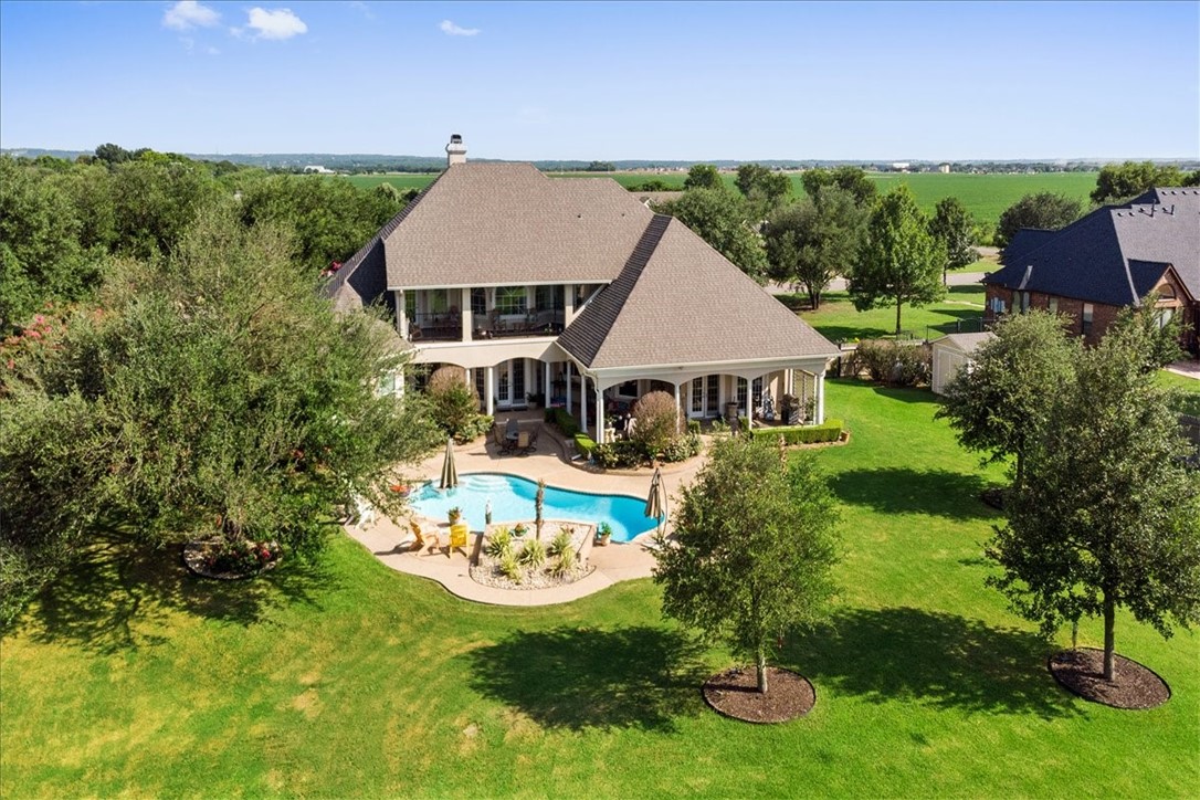 1021 Park Ridge Circle McGregor, TX 76657 - Photo 46 of 48 a aerial view of a house with a yard table and chairs