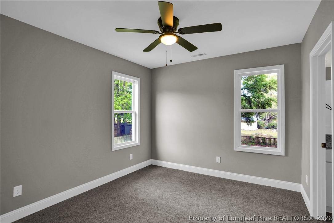 610 North Main Street Raeford, NC 28376 - Photo 15 of 28 an empty room with windows and ceiling fan
