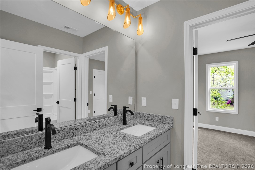 610 North Main Street Raeford, NC 28376 - Photo 16 of 28 a bathroom with a granite countertop sink and a window