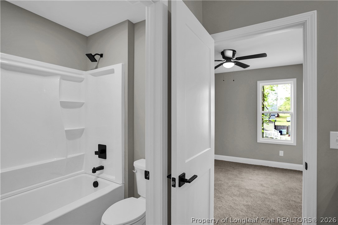 610 North Main Street Raeford, NC 28376 - Photo 17 of 28 a bathroom with a shower bathtub and a toilet