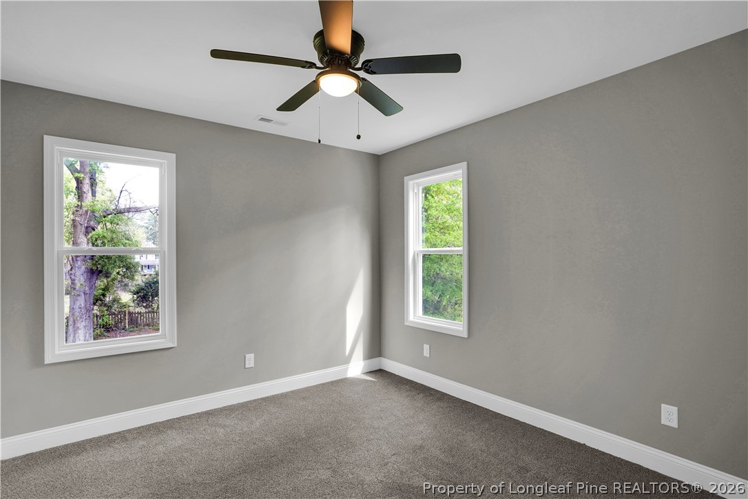610 North Main Street Raeford, NC 28376 - Photo 18 of 28 an empty room with windows and ceiling fan
