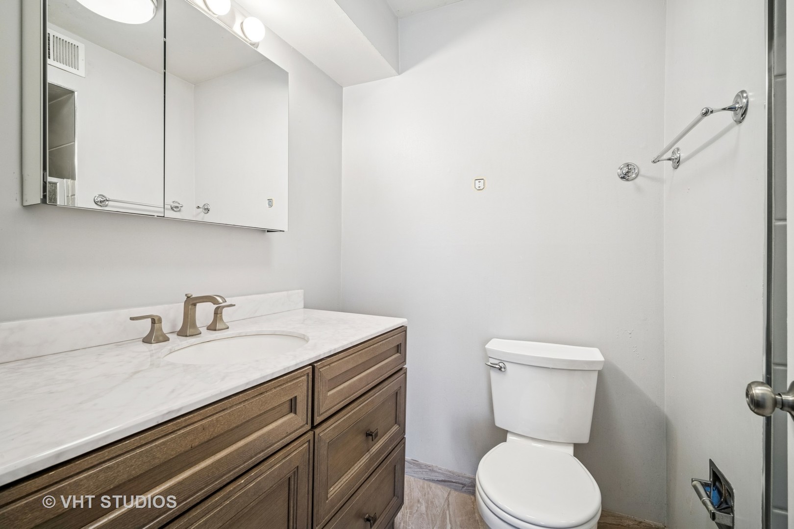 1499 Shermer Road, Unit 201E Northbrook, IL 60062 - Photo 12 of 16 a bathroom with a toilet sink and mirror