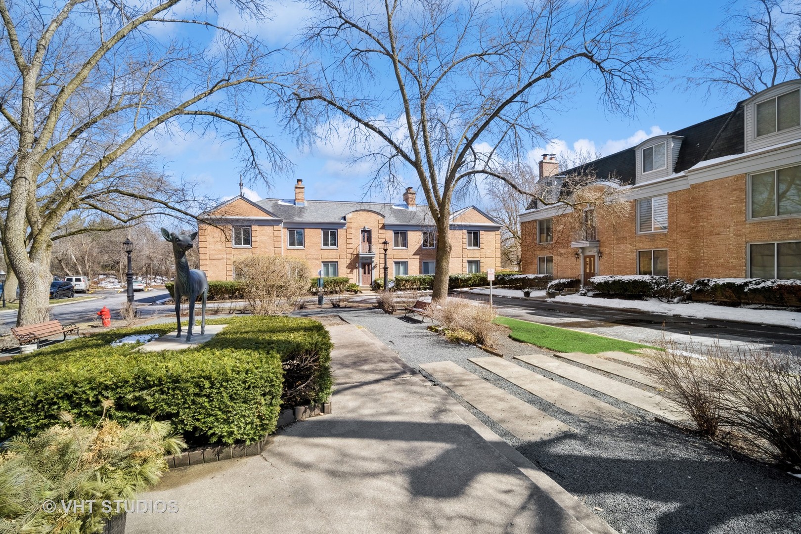 1499 Shermer Road, Unit 201E Northbrook, IL 60062 - Photo 3 of 16 a front view of a building with a garden