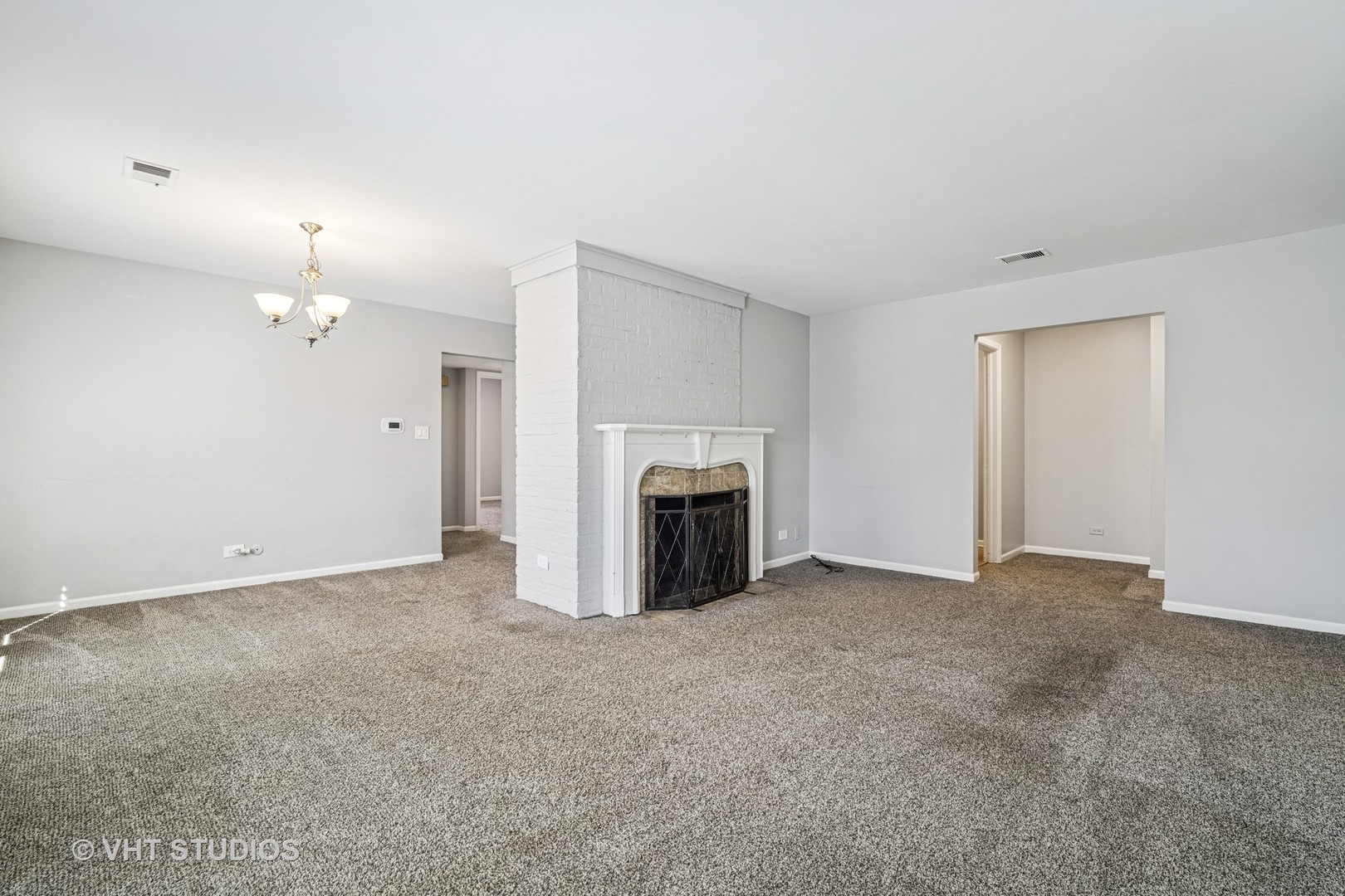 1499 Shermer Road, Unit 201E Northbrook, IL 60062 - Photo 5 of 16 a view of an empty room with a fireplace