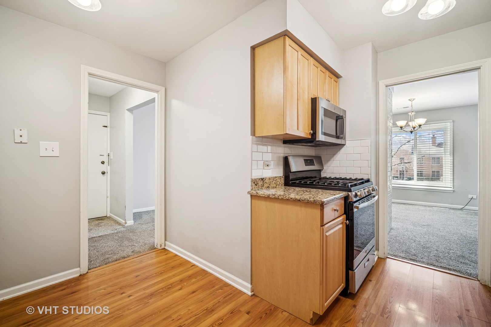 1499 Shermer Road, Unit 201E Northbrook, IL 60062 - Photo 8 of 16 a kitchen with stainless steel appliances granite countertop a stove a sink and a refrigerator