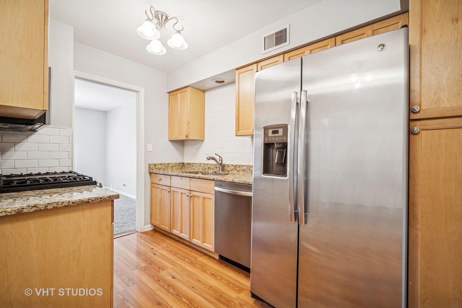 1499 Shermer Road, Unit 201E Northbrook, IL 60062 - Photo 9 of 16 a kitchen with stainless steel appliances granite countertop a refrigerator and a stove top oven