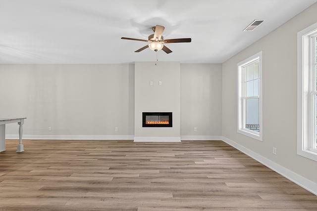 2562 Harbor Ridge Pass Gainesville, GA 30507 - Photo 4 of 27 a view of an empty room with wooden floor and a window