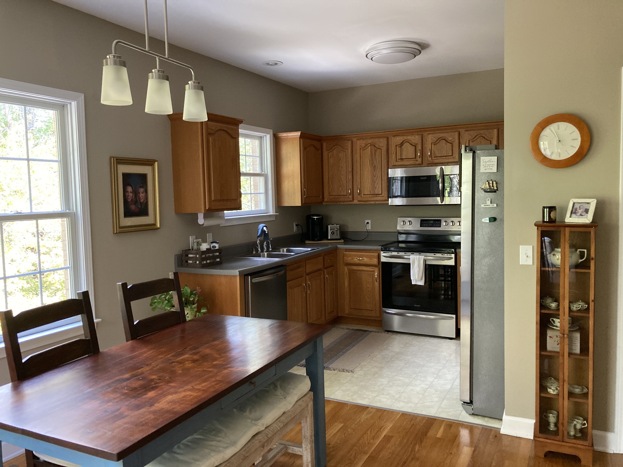 1225 Meeks Cemetery Road Burns, TN 37029 - Photo 20 of 66 a kitchen with stainless steel appliances granite countertop a stove top oven a sink dishwasher a dining table and chairs with wooden floor