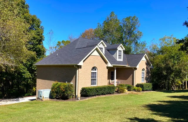 a front view of a house with a yard