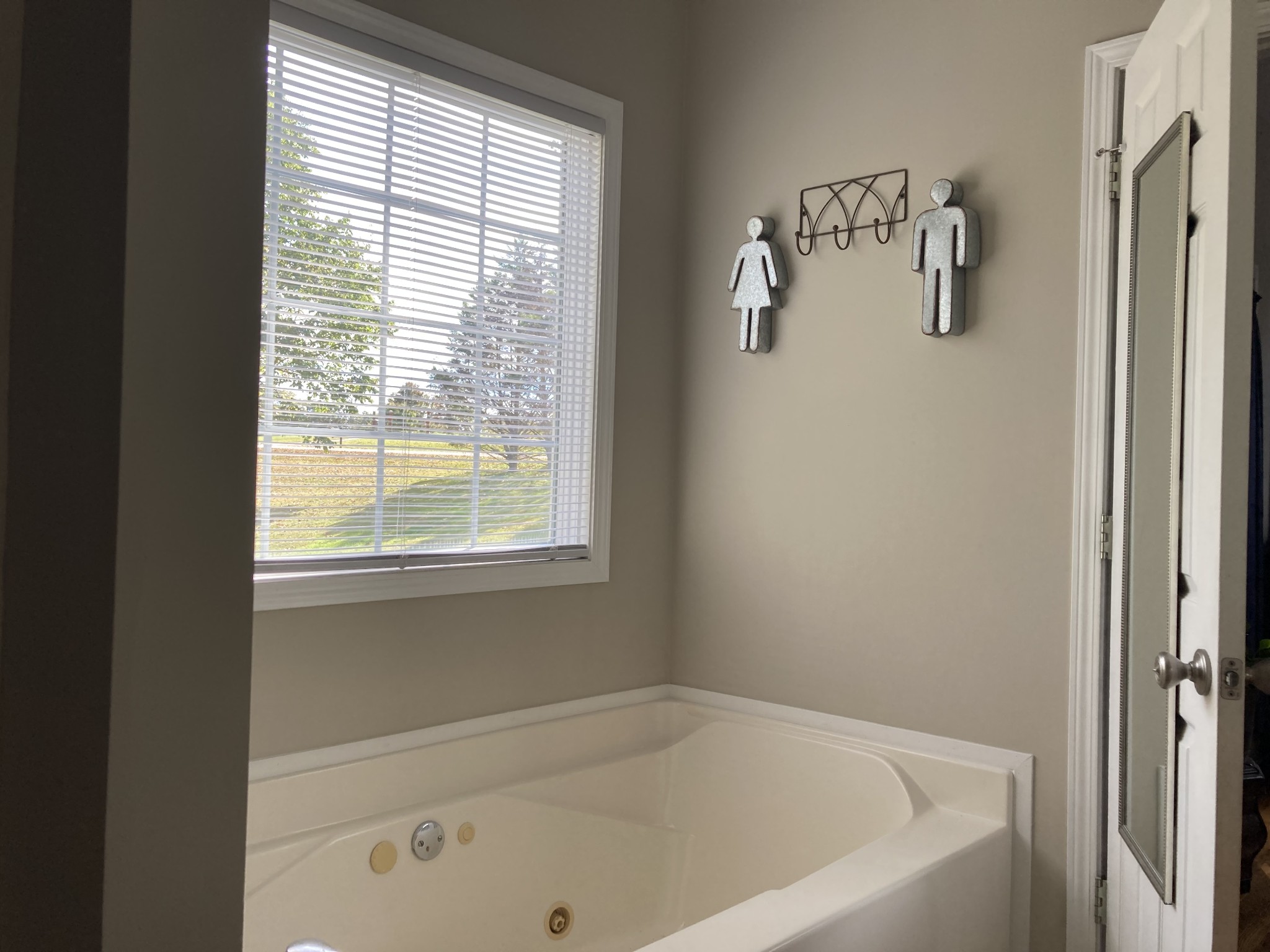 1225 Meeks Cemetery Road Burns, TN 37029 - Photo 38 of 66 a white bath tub sitting next to a window