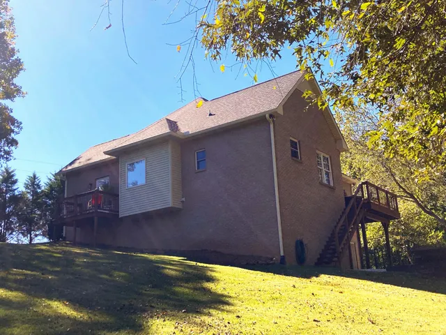 a view of a house with a large tree