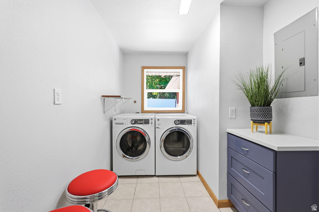 1180 North 400 East Bountiful, UT 84010 - Photo 28 of 50 Laundry room featuring tile flooring, a wood-framed window, a built-in countertop, and cabinetry with drawer storage