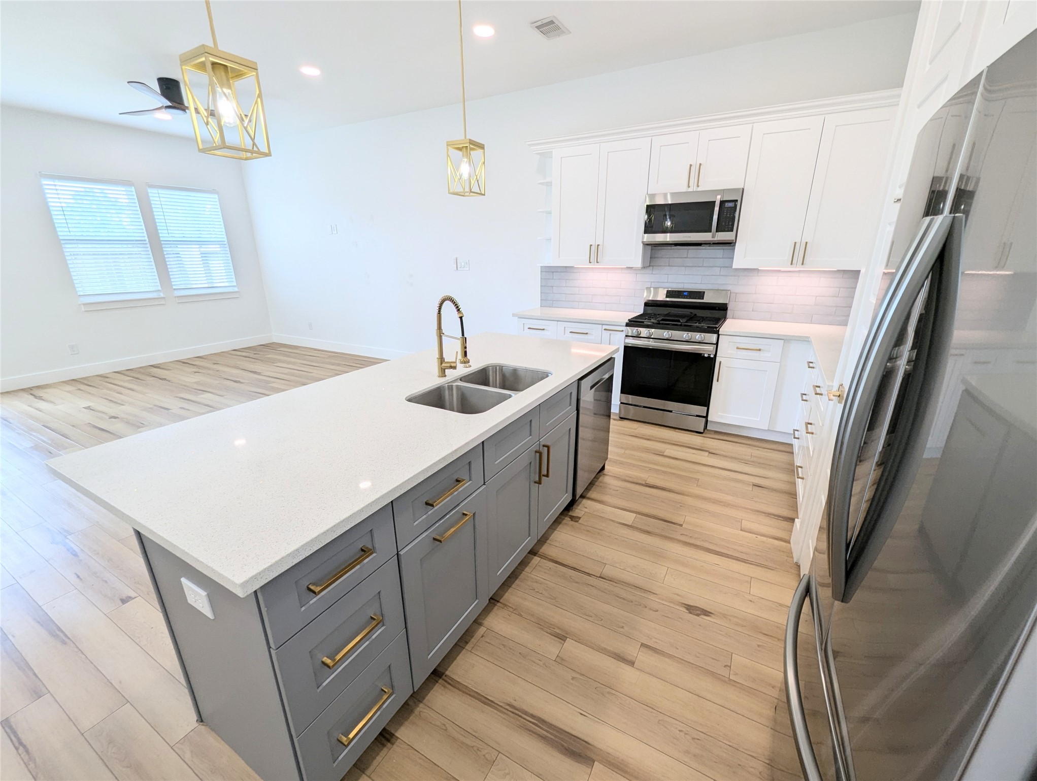 4913 Fisk Street Houston, TX 77009 - Photo 6 of 27 a kitchen with stainless steel appliances a sink stove and refrigerator