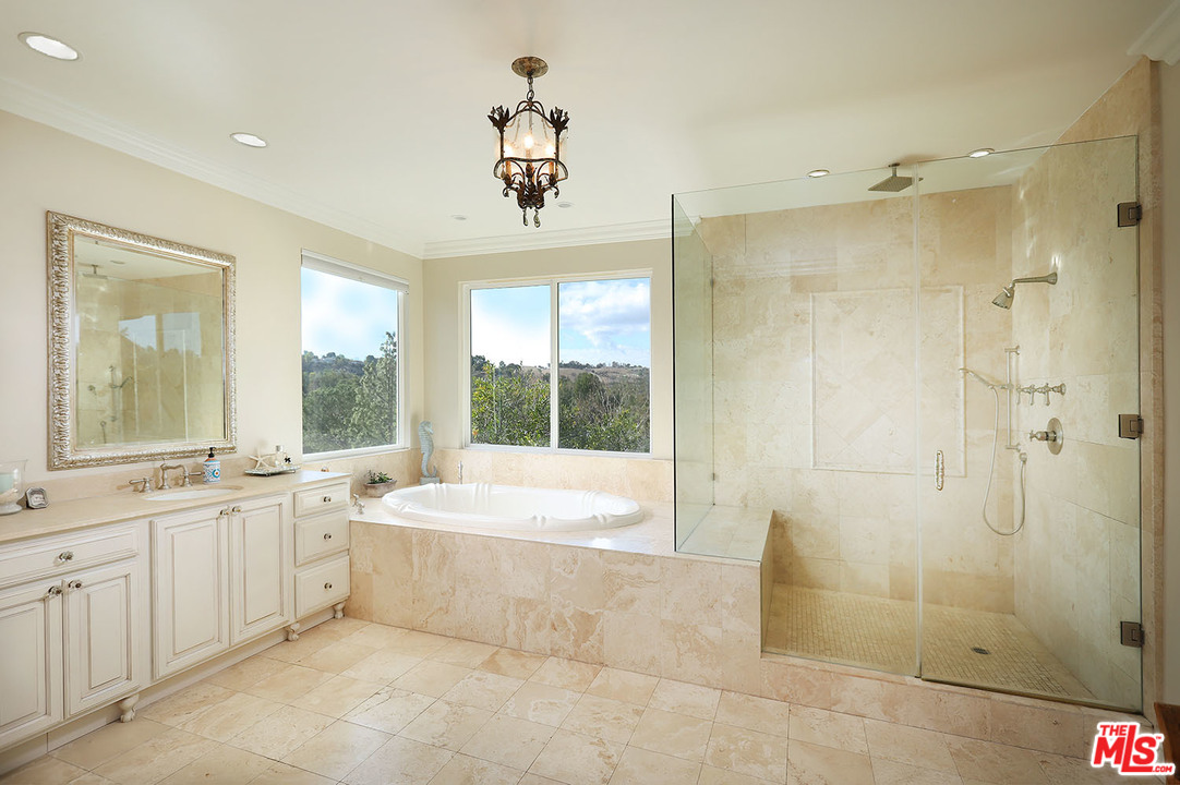 5845 Hilltop Road Hidden Hills, CA 91302 - Photo 11 of 16 a large spacious bathroom with a large tub shower and sink